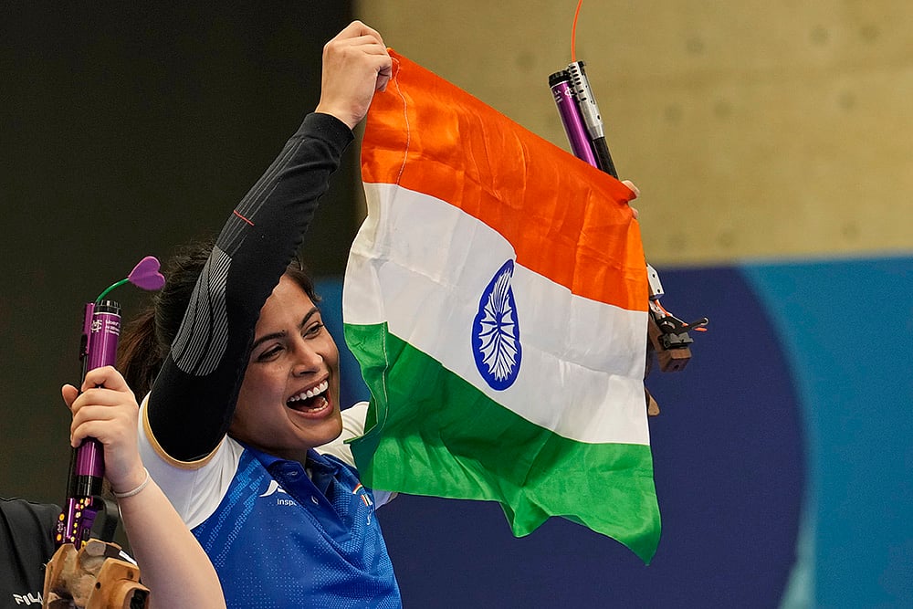 Manu Bhaker celebrates with the Indian flag - | Photo: AP/Manish Swarup